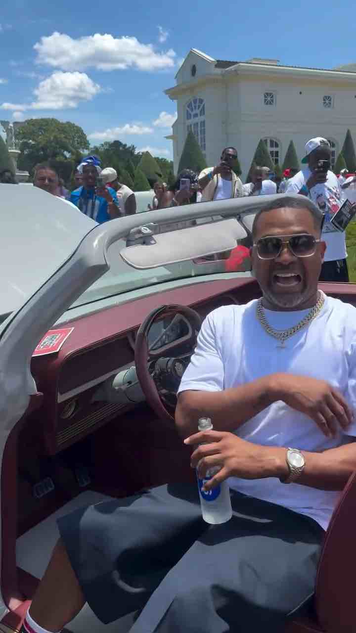 I wanna be a baller, shot caller, 20 inch blades, on the Impala - Mike Epps listened to that beautiful, legendary 1999 tune by Lil Troy at the 2026 Rick Ross Car & Bike Show